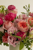 IN𝓃 Floral Studio Bloom Elegance arrangement: pink peonies, garden roses, ranunculus, lisianthus, spray roses, gerberas, jasmine in a ribbed sage green vase.