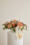 IN𝓃 Floral Studio Peach Garden arrangement: peach roses, ranunculus, and greenery in a white ceramic bowl with satin ribbons.