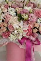 IN𝓃 Floral Studio Rosé Belle arrangement: lavender & ivory roses, white lilies, lisianthus, hydrangeas, carnations, spray roses, eucalyptus in a pink vase.