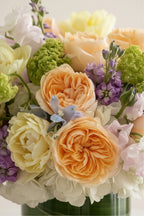 IN𝓃 Floral Studio Spring Garden Deluxe arrangement with roses, tulips, delphiniums, viburnum, stock, sweet peas, and hydrangeas in a glass vase.
