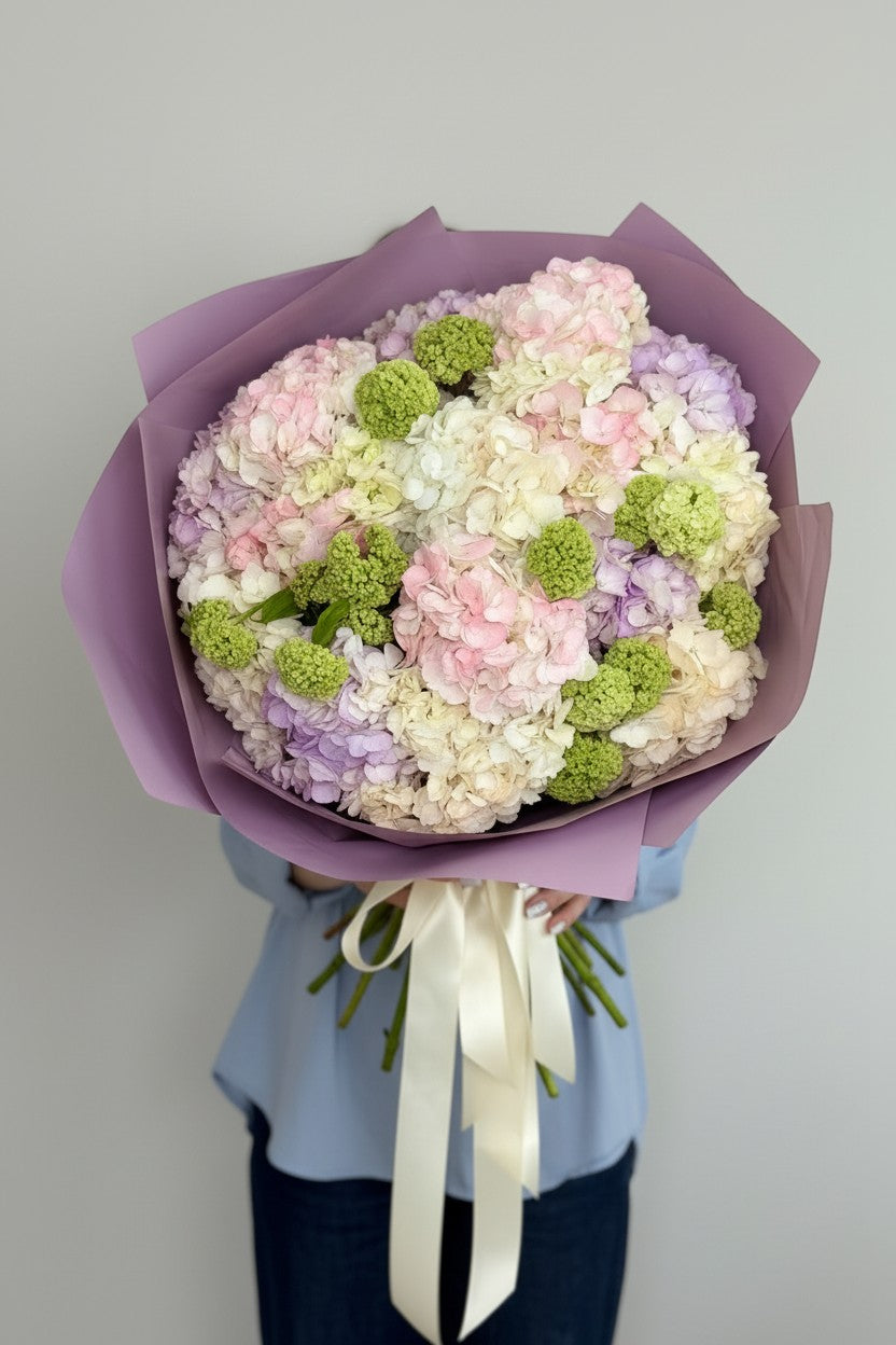 IN𝓃 Floral Studio mixed hydrangea bouquet in pastel pink, lavender, ivory, and blush with green viburnum accents. Size M.