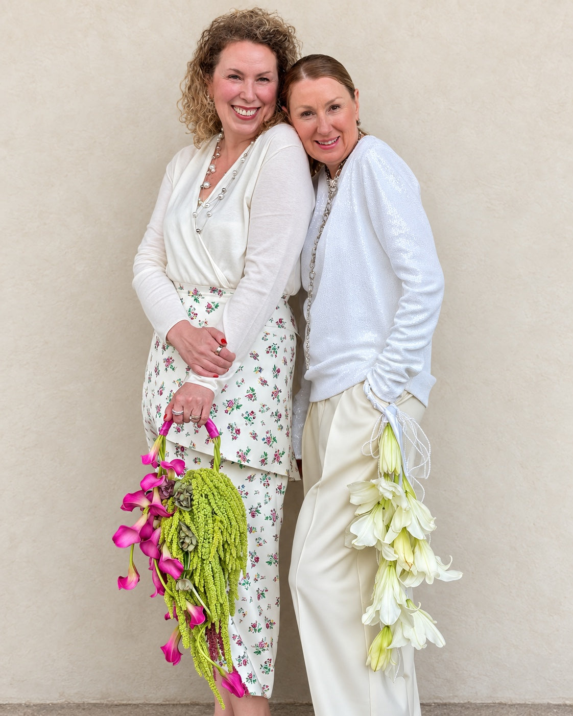 The two sisters behind INN Floral Studio holding floral handbags